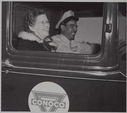 Blanche Nowlin & Pete Martinez laughing in truck with Conoco emblem 1940