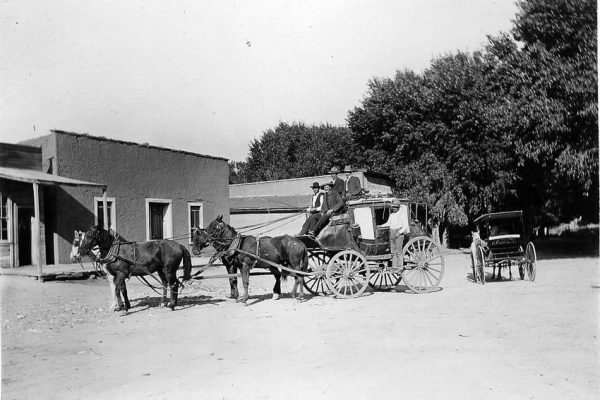 Mountain Pride stagecoach with 5 men parked in Hillsboro